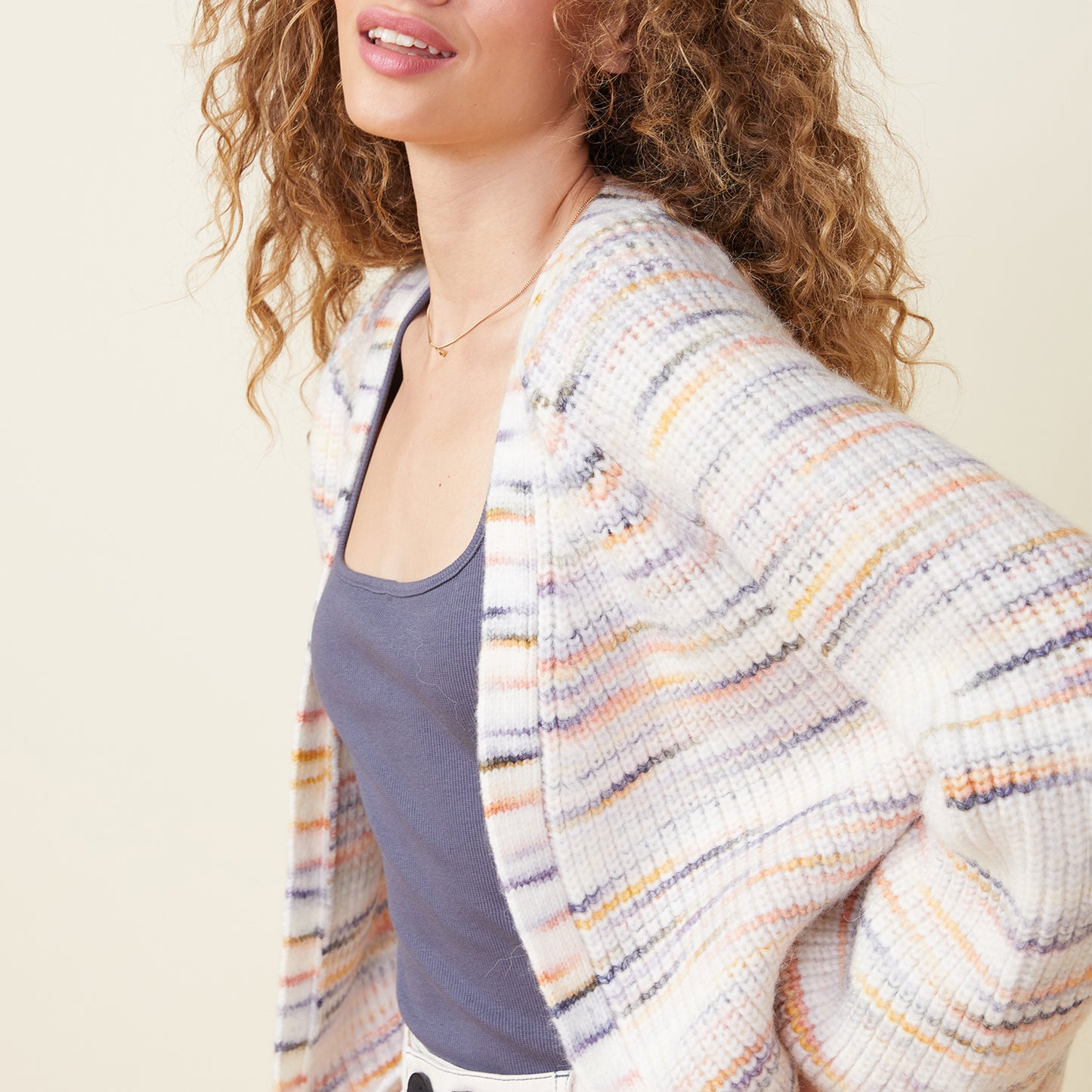 Front view of model wearing the space dye sweater cardigan in fruity pebbles.