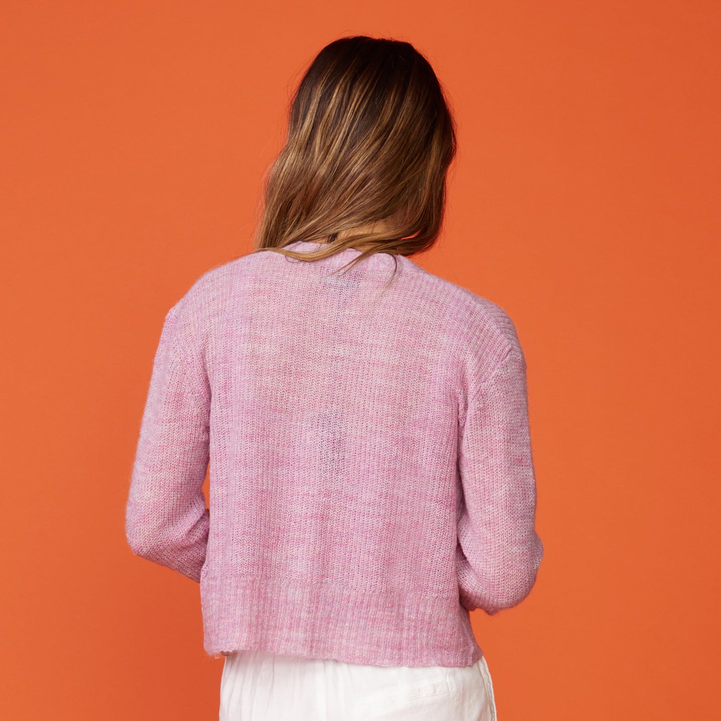 Back view of model wearing the mohair cardigan in raspberry rose.