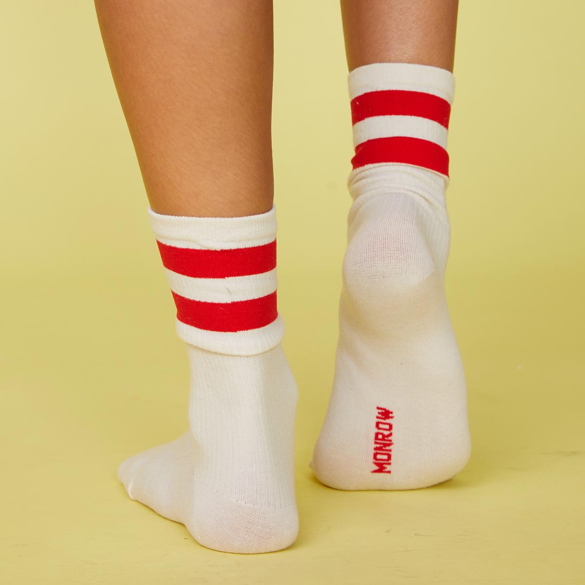 Back view of models feet wearing the stripe socks in blood red.