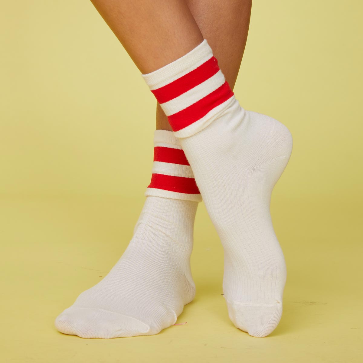 Front view of models feet wearing the stripe socks in blood red.