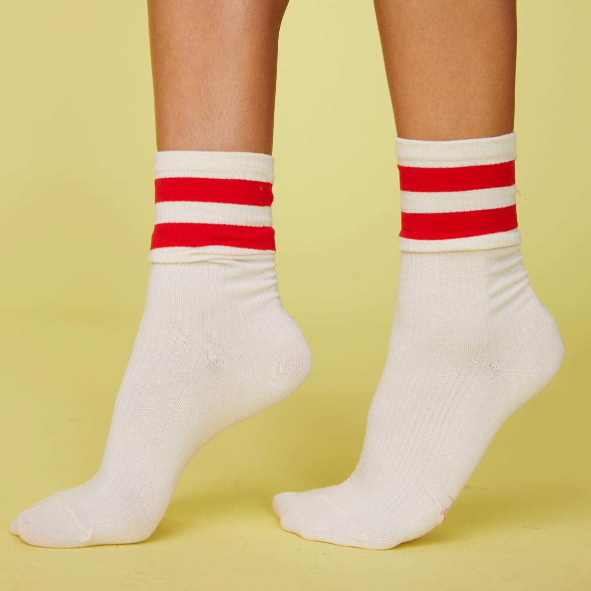 Side view of models feet wearing the stripe socks in blood red.