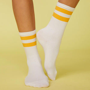 Front view of model's feet wearing the stripe socks in marigold.