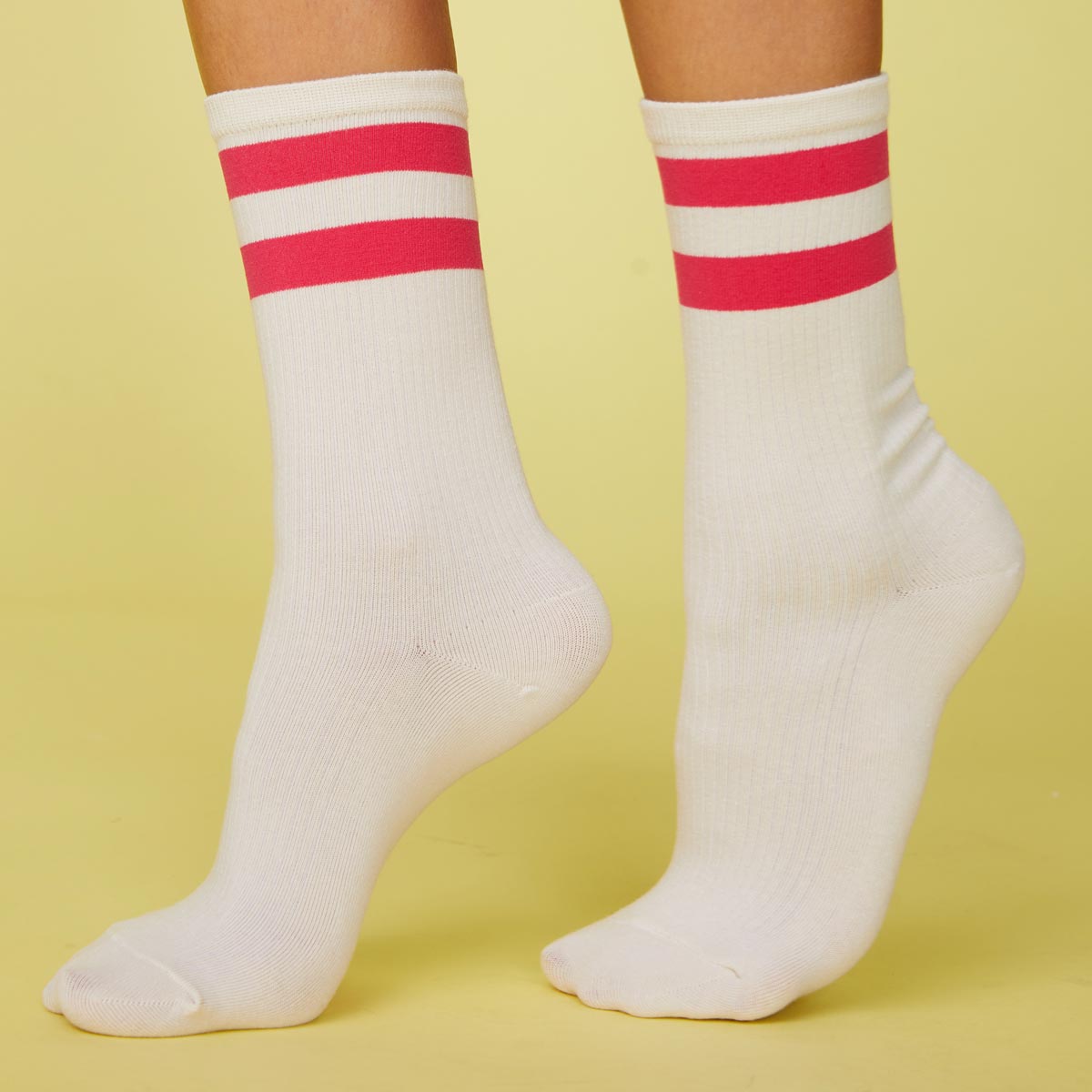 Side view of model's feet wearing the stripe socks in raspberry.