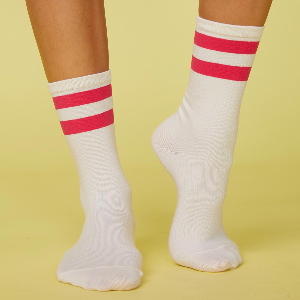 Front view of model's feet wearing the stripe socks in raspberry.