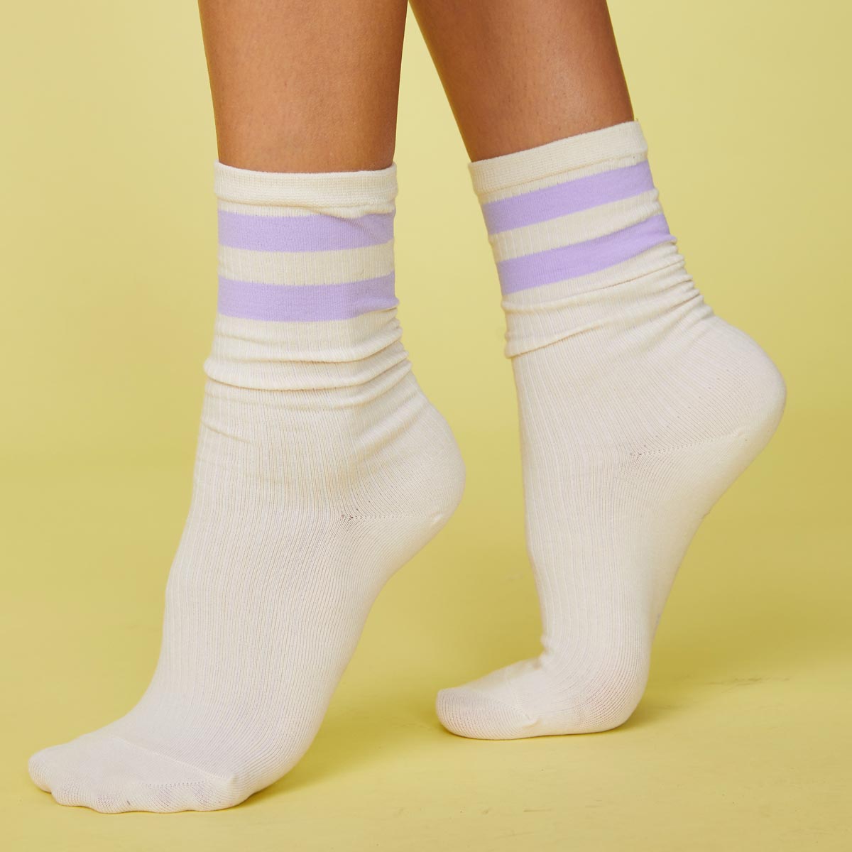 Side view of model's feet wearing the stripe socks in wisteria.
