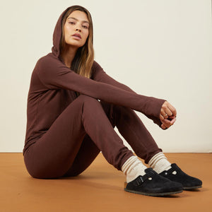 Side view of model sitting while wearing the supersoft vintage sweats in dark oak.