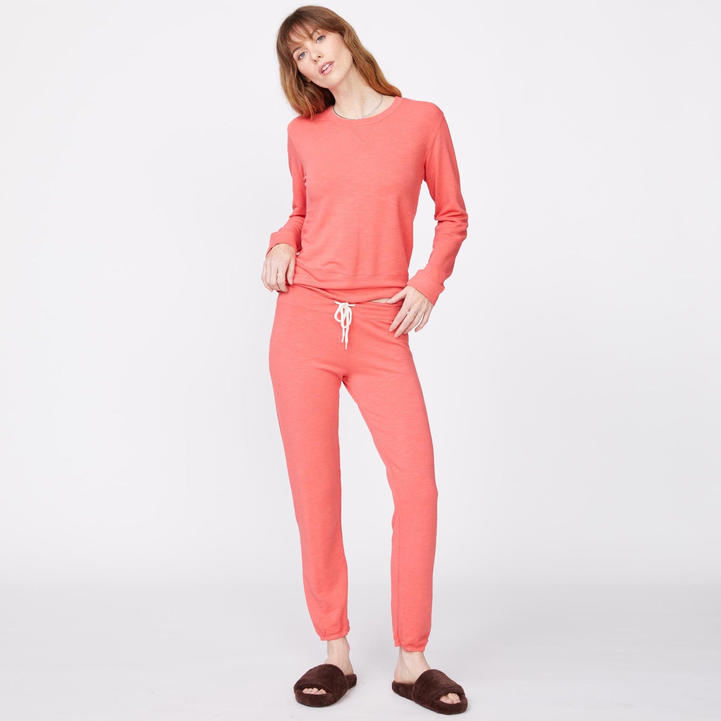 Front view of model wearing the supersoft crew neck sweatshirt in watermelon.