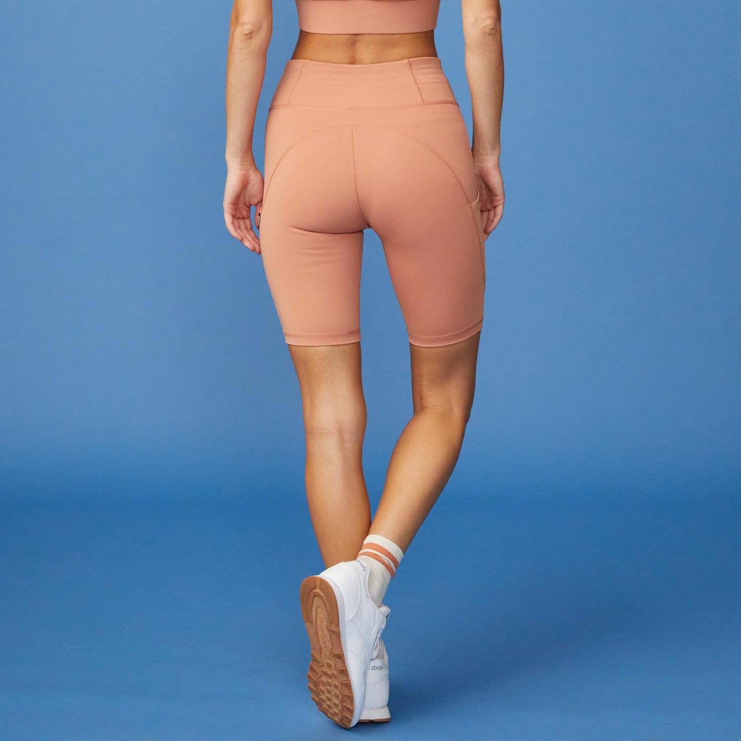 Back View of model wearing the Movement Shorts in Faded Rust