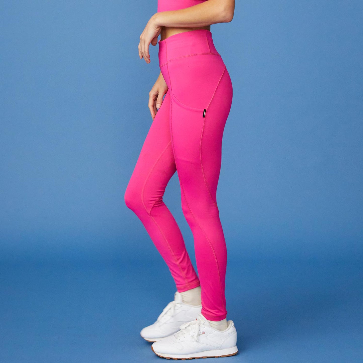 Side View of model wearing the Movement High Rise Legging in Raspberry
