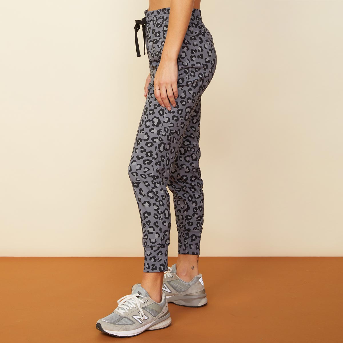 Side view of model wearing the leopard movement jogger in vintage black.