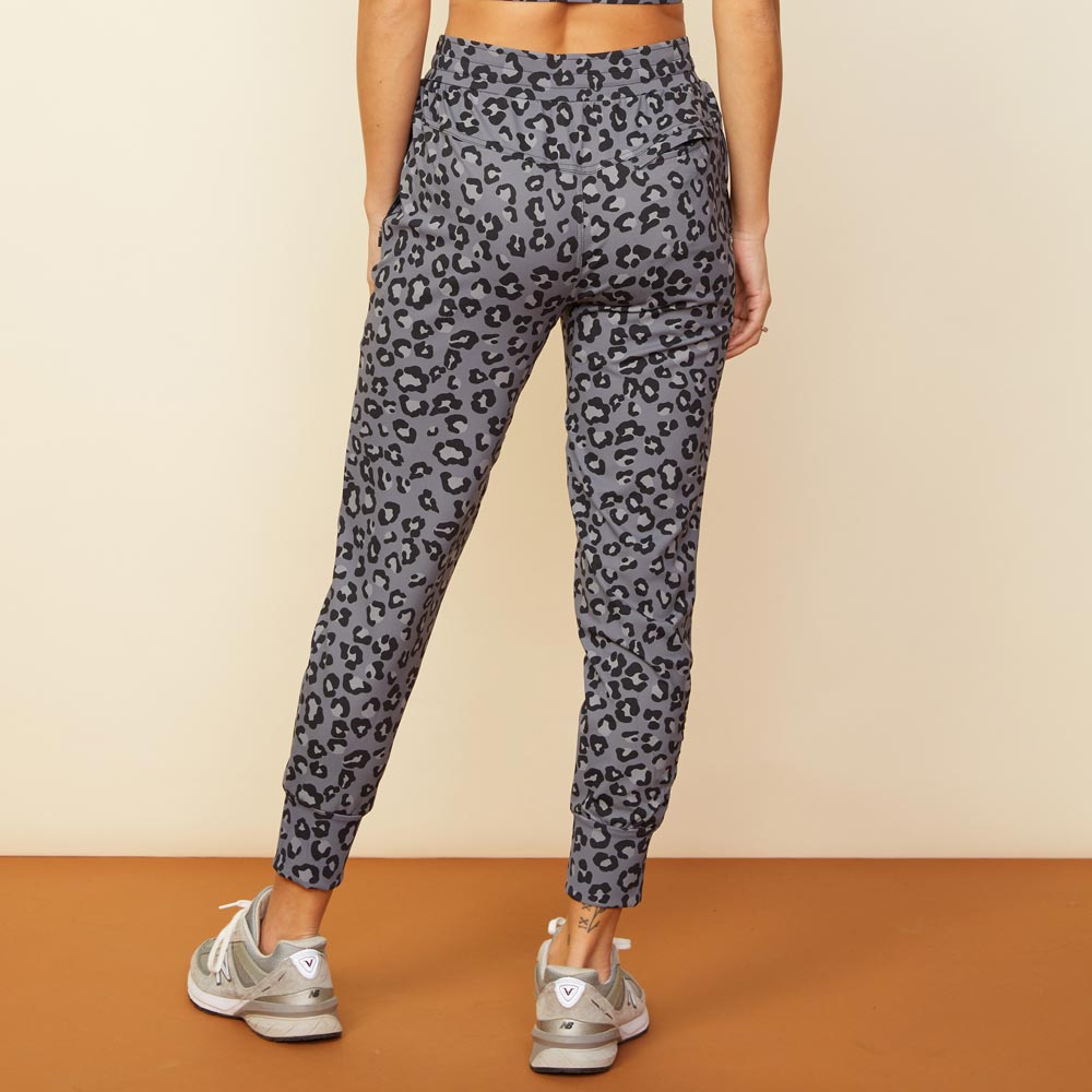 Back view of model wearing the leopard movement jogger in vintage black.