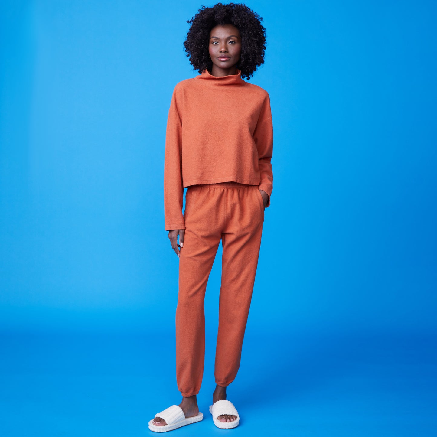 Front view of model wearing the fuzzy boyfriend sweat in faded rust.