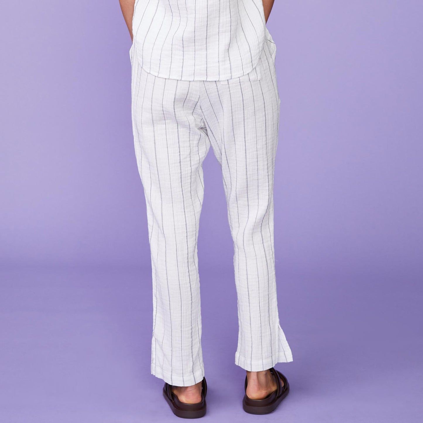 Back View of model wearing the Pinstripe Gauze Pants in White