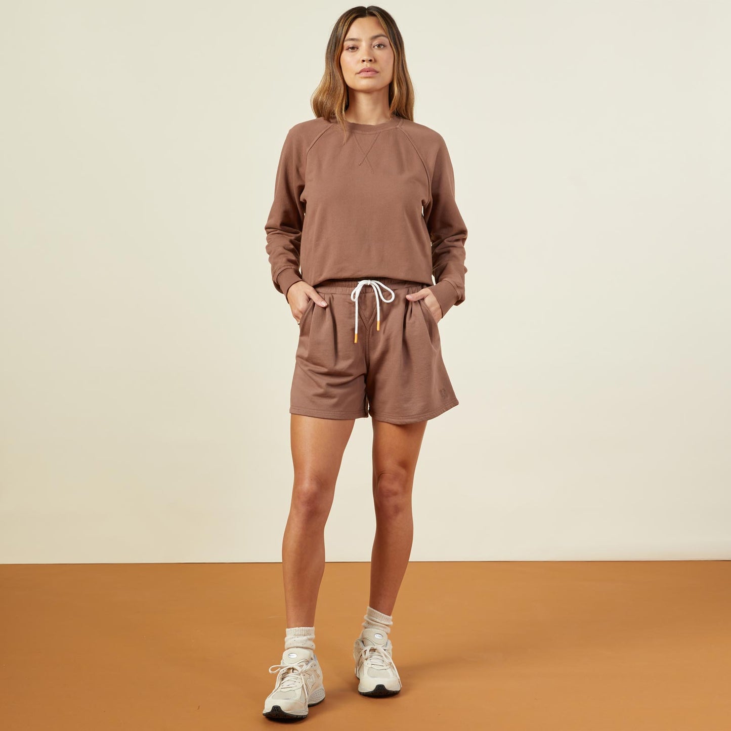 Front view of model wearing the 90's classic sweat short in dusty cocoa.