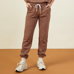 Front view of model wearing the 90's classic joggers in dusty cocoa.