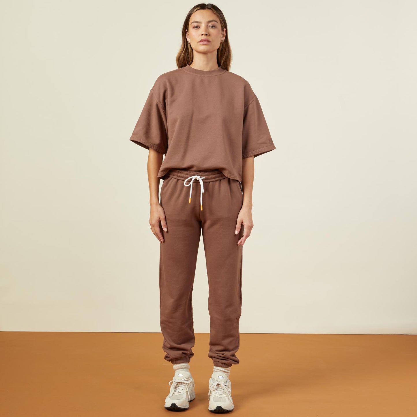 Front view of model wearing the 90's classic joggers in dusty cocoa.