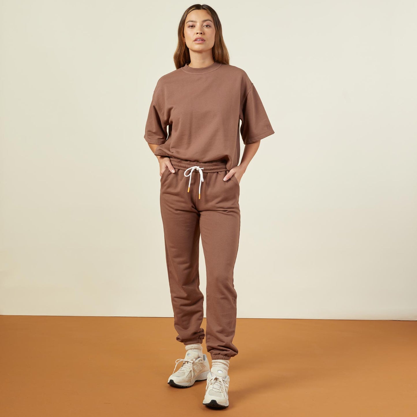 Front view of model wearing the 90's classic joggers in dusty cocoa.
