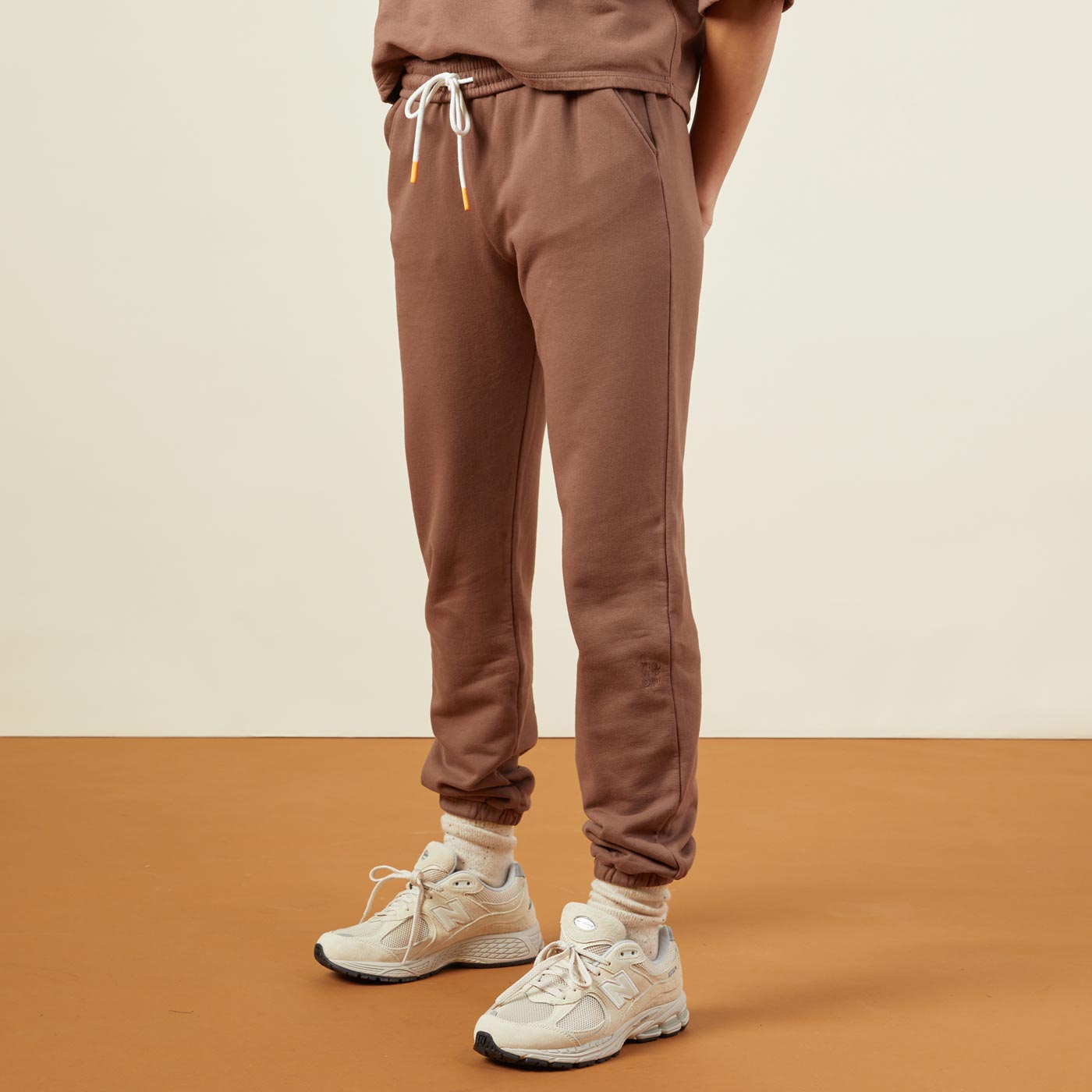Side view of model wearing the 90's classic joggers in dusty cocoa.