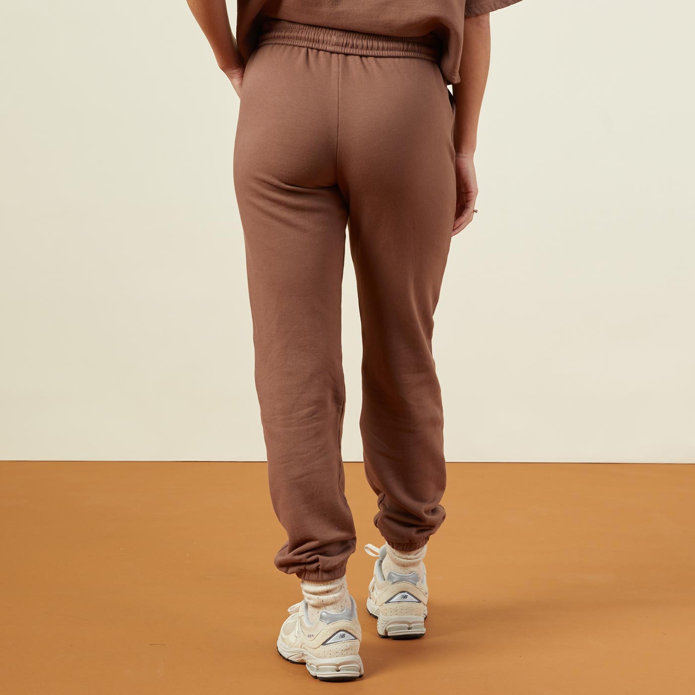 Back view of model wearing the 90's classic joggers in dusty cocoa.