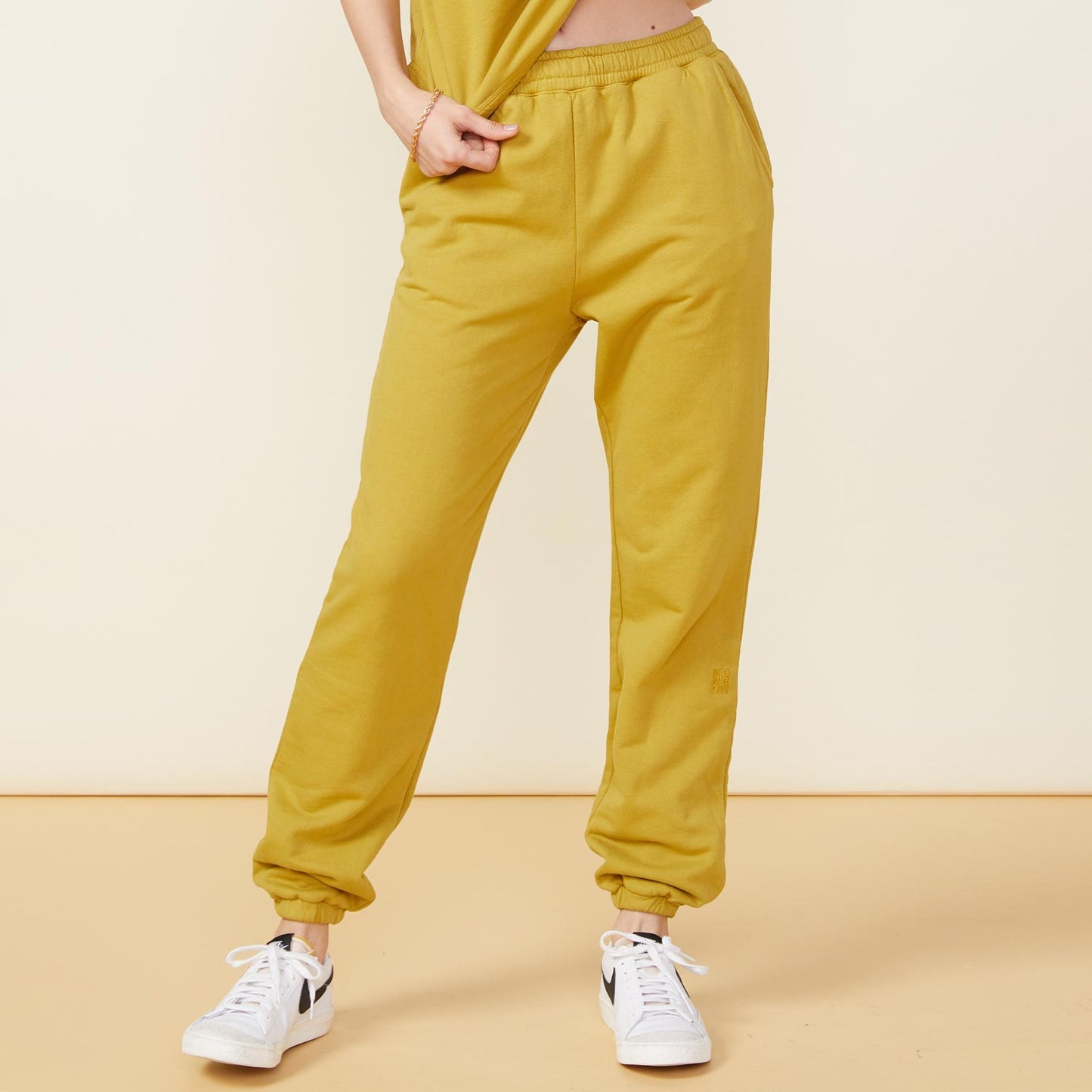Front view of model wearing the 90's classic joggers in golden olive.