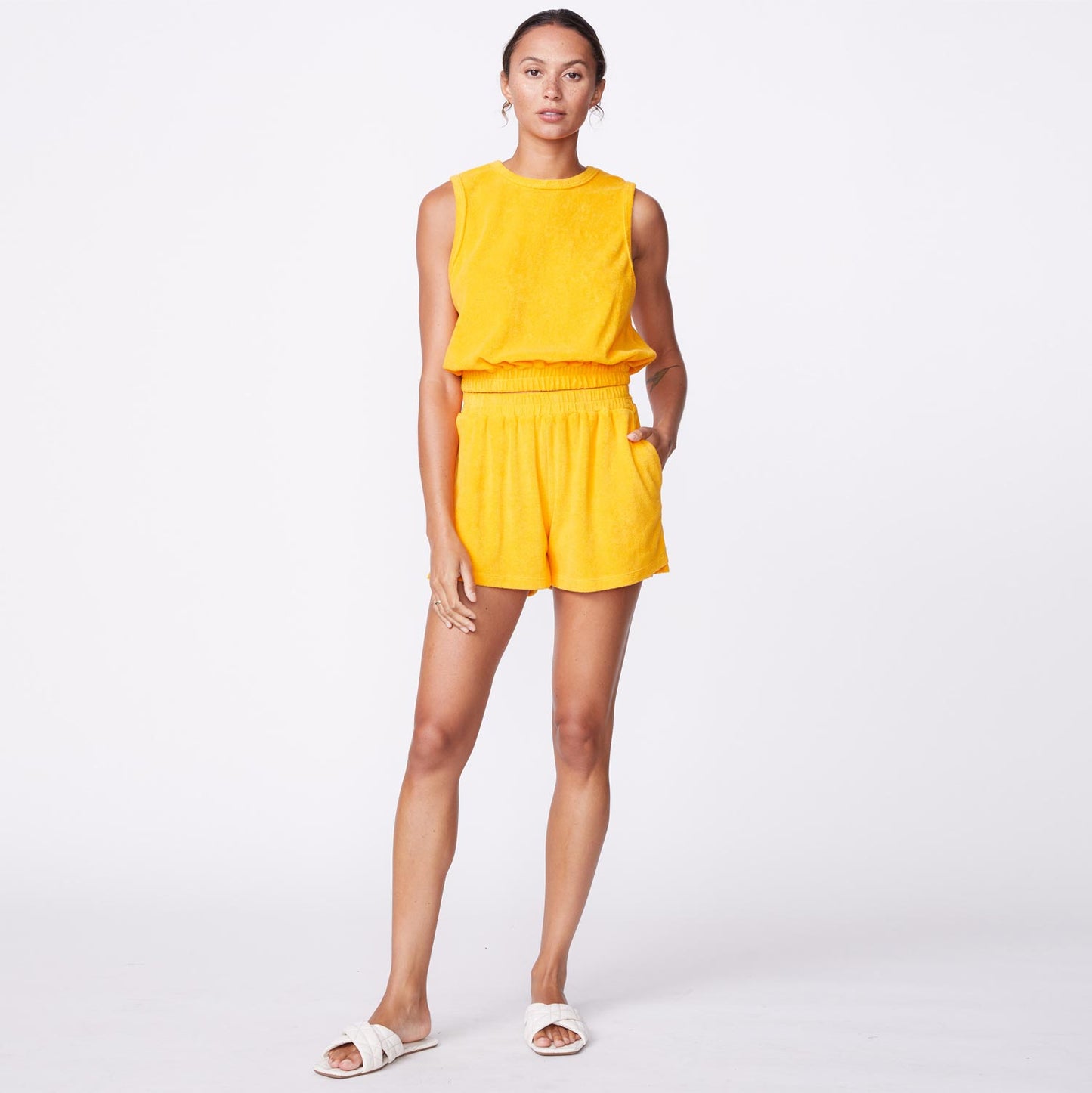 Front view of model wearing the terry cloth tank in marigold.