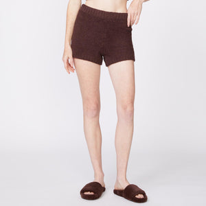 Front view of model wearing the plush sweater shorts in cocoa.