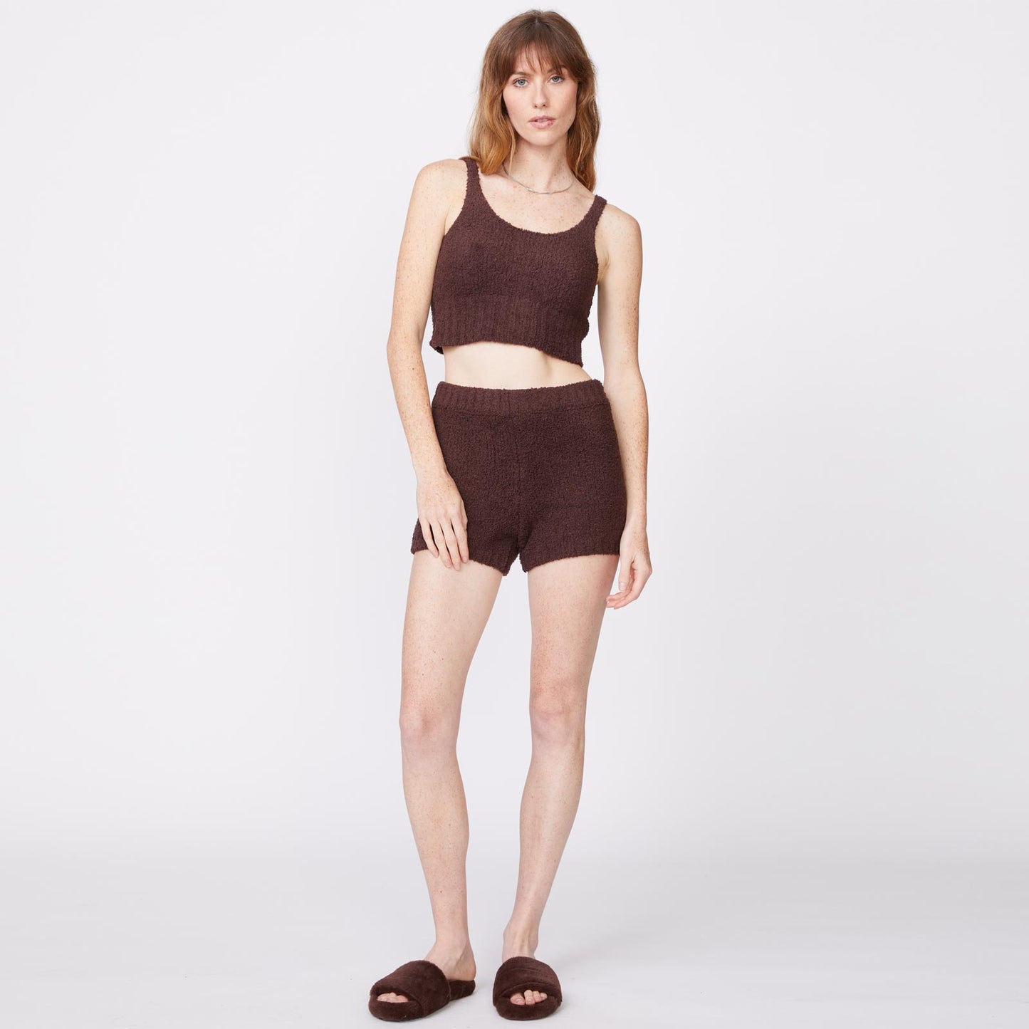Front view of model wearing the plush sweater shorts in cocoa.