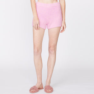 Front view of model wearing the plush sweater shorts in orchid.