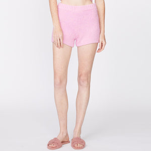 Front view of model wearing the plush sweater shorts in orchid.