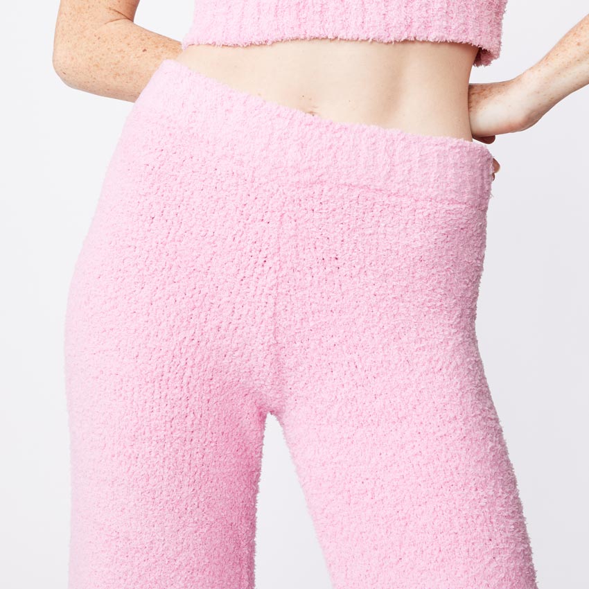 Close up view of model wearing the plush sweater pants in orchid.