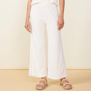 Front view of model wearing the terry cloth high waisted flare sweat in pearl.