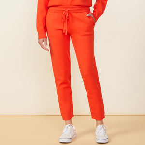 Front view of model wearing the supersoft sweater knit cuffed jogger in electric coral.