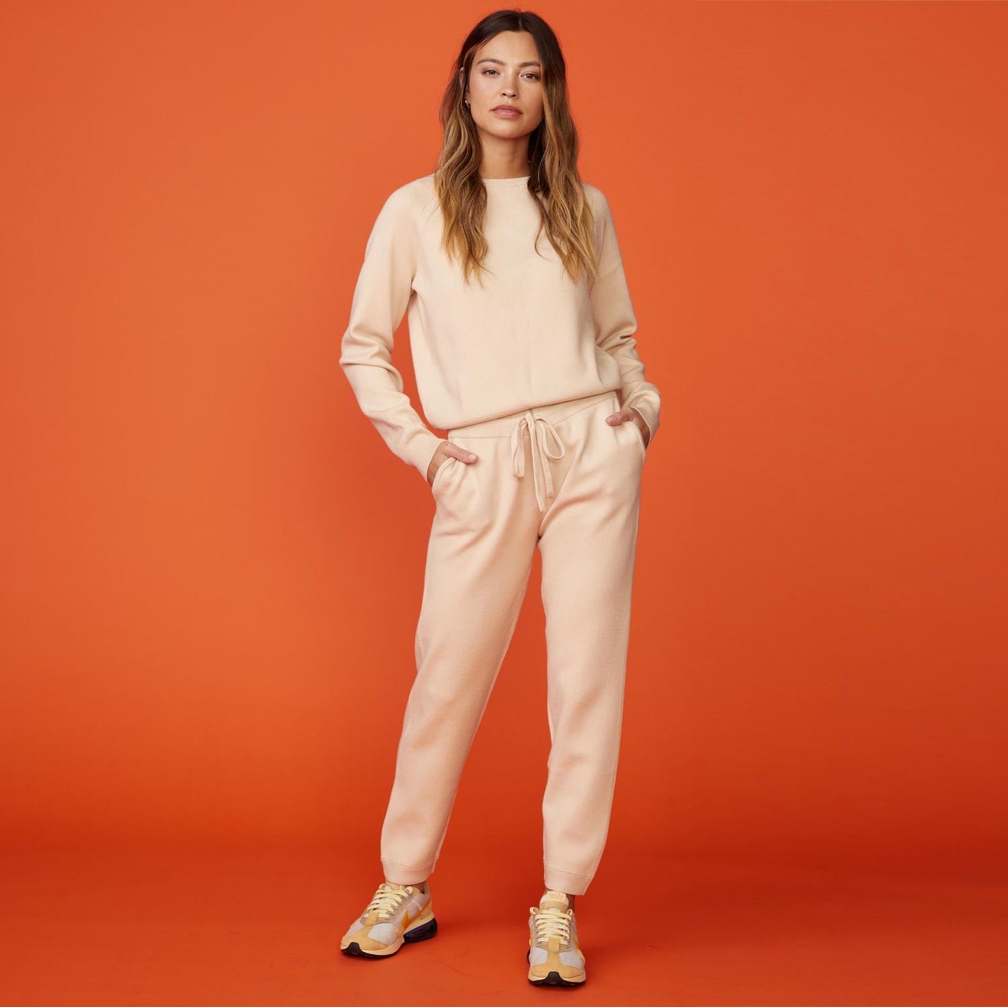 Front view of model wearing the supersoft sweater knit cuffed jogger in off white.