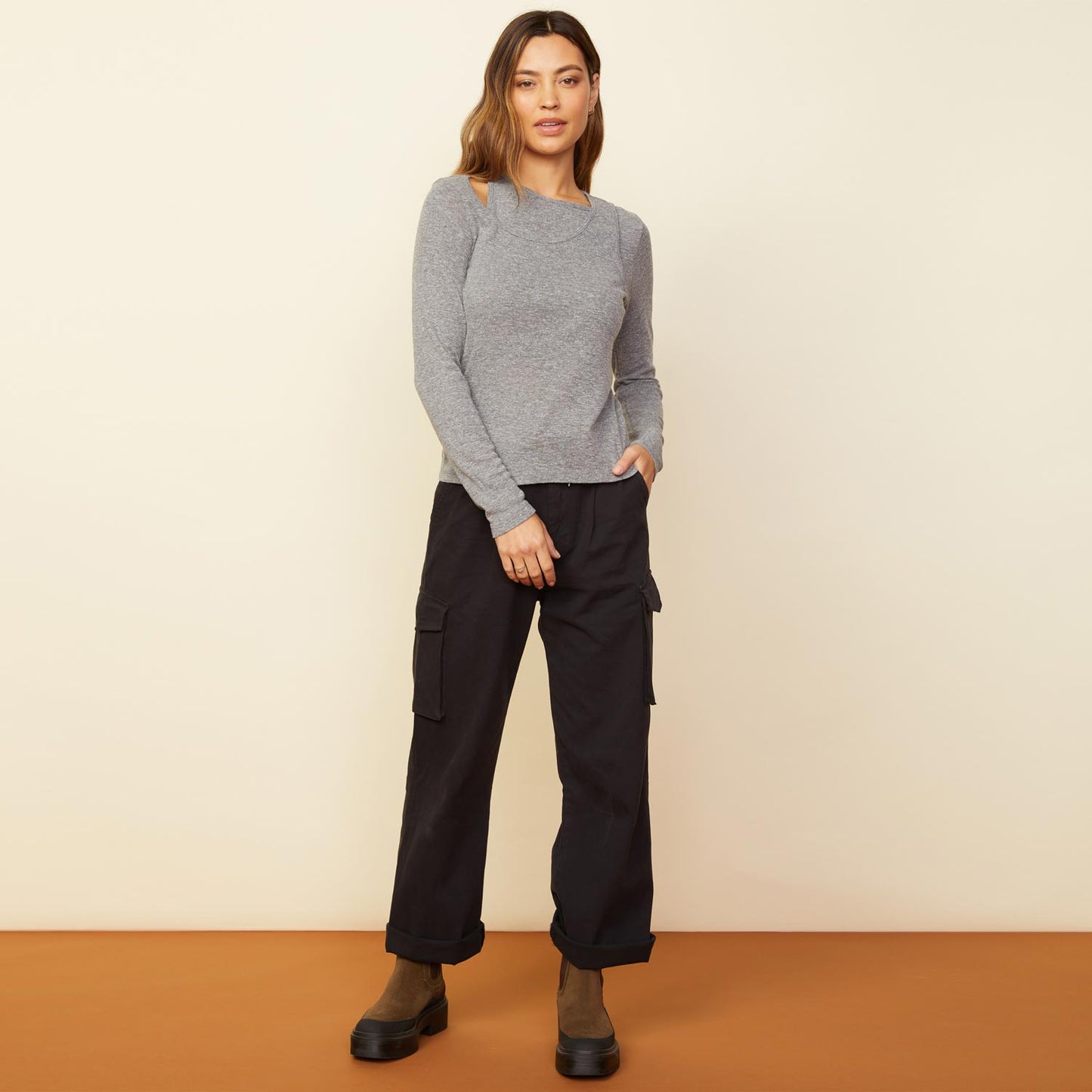 Front view of model wearing the asymmetric long sleeve top in granite.