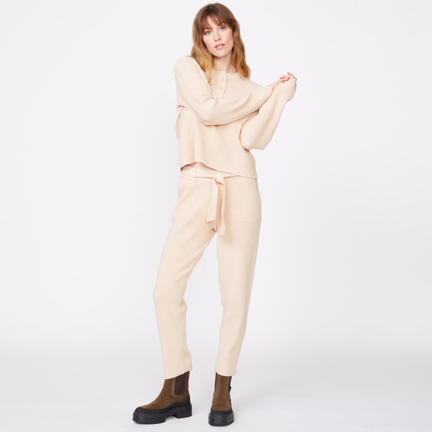 Front view of model wearing the supersoft sweater knit waffle sweats in off white.