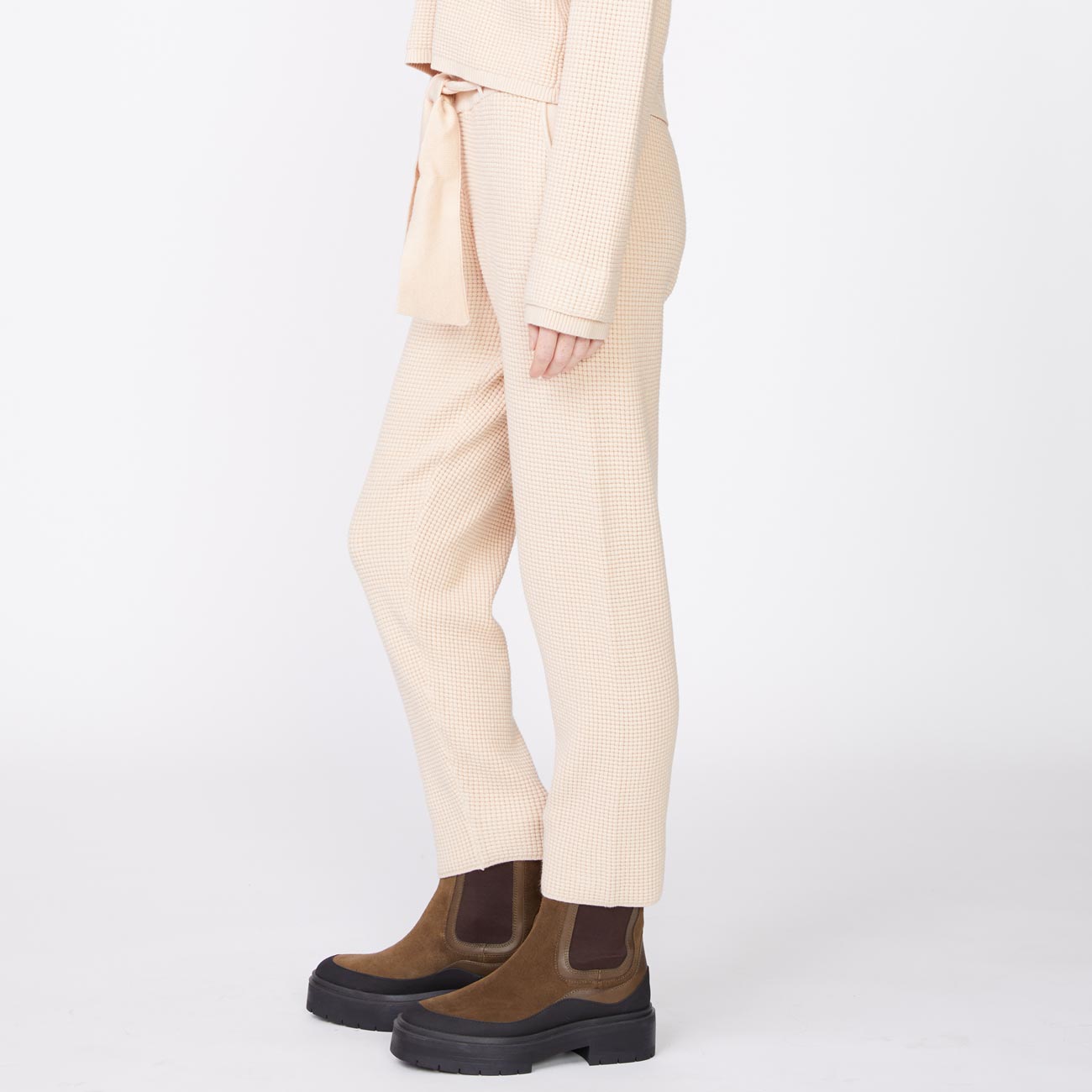 Side view of model wearing the supersoft sweater knit waffle sweats in off white.