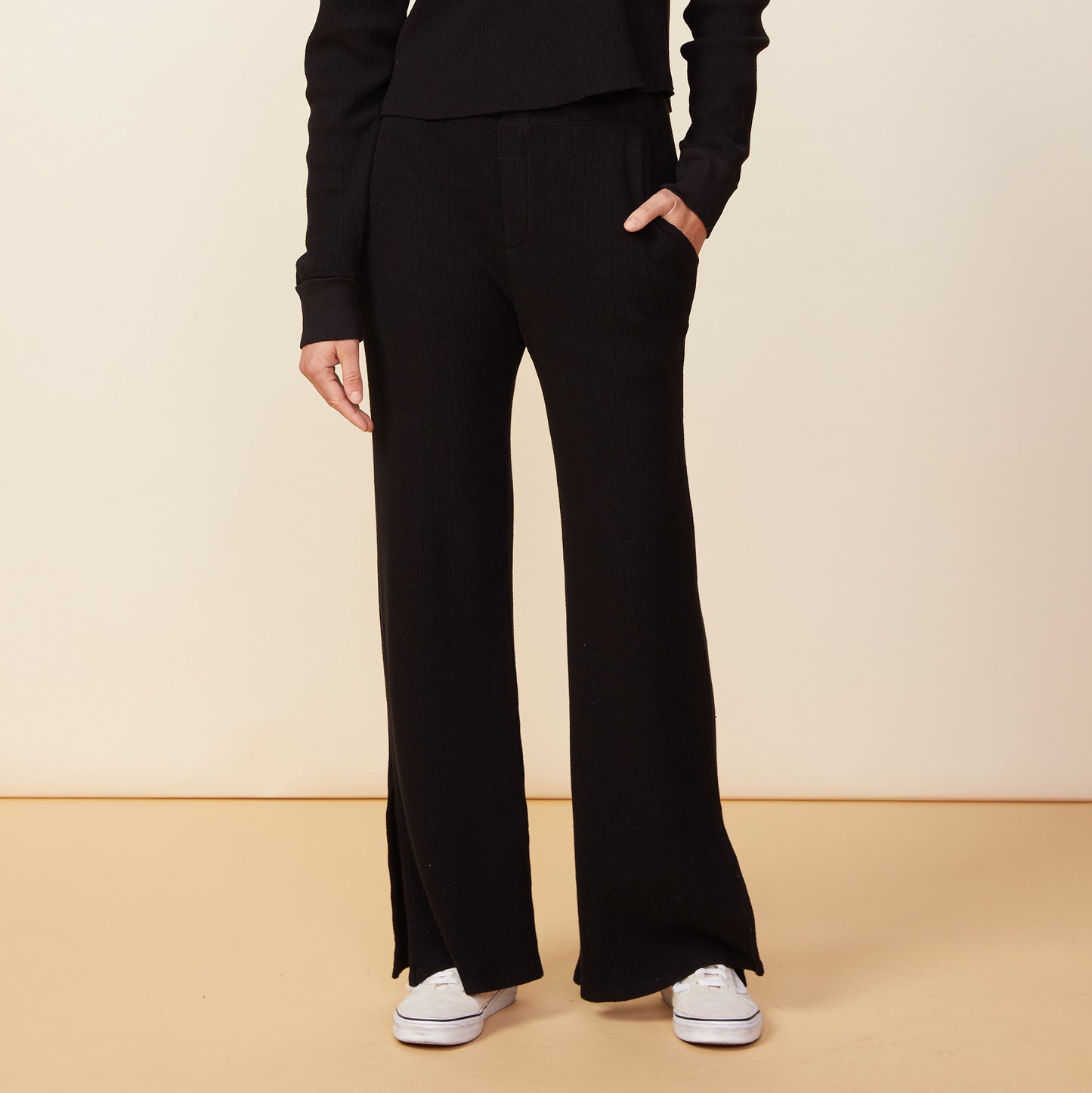 Front view of model wearing the thermal pants in black.