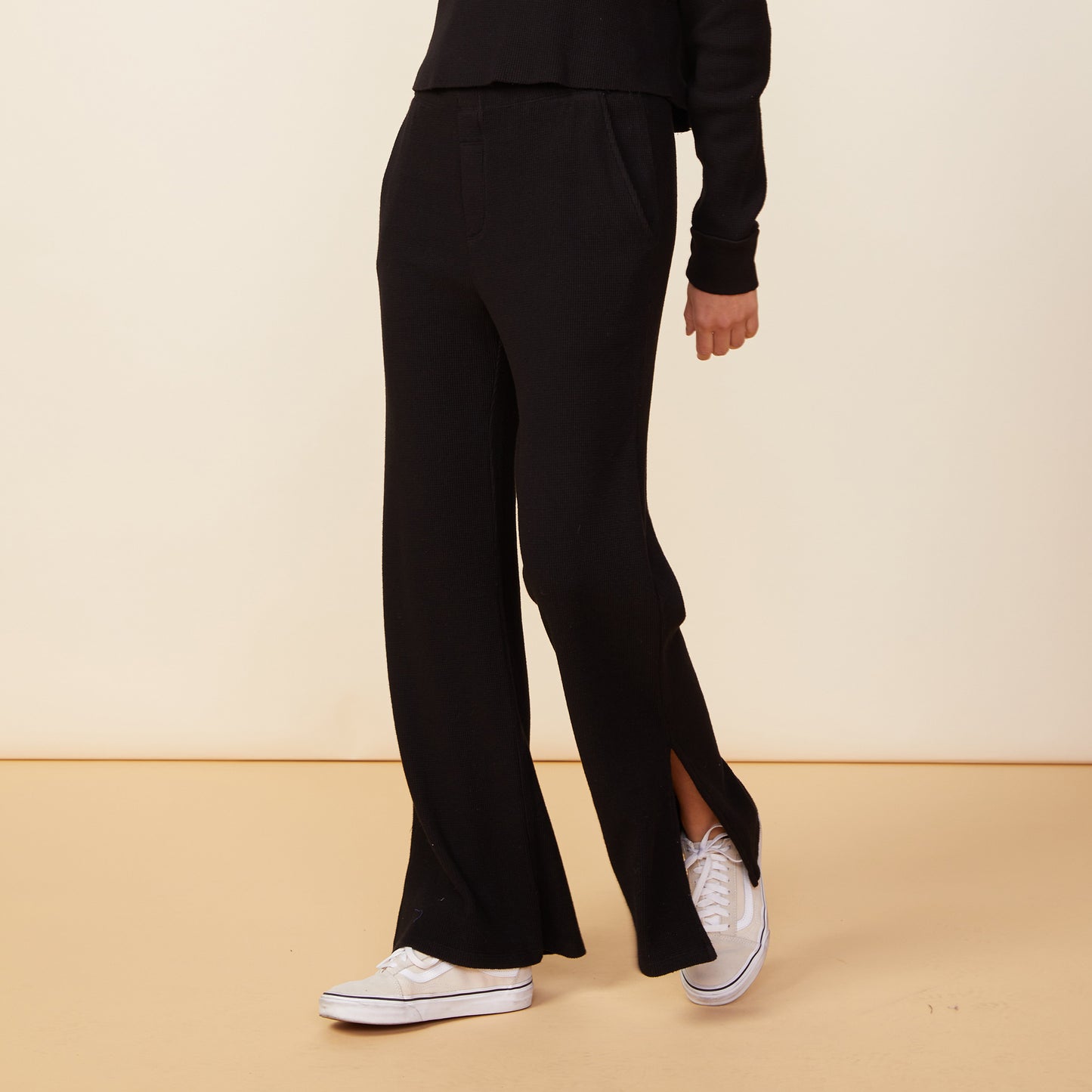 Front view of model wearing the thermal pants in black.