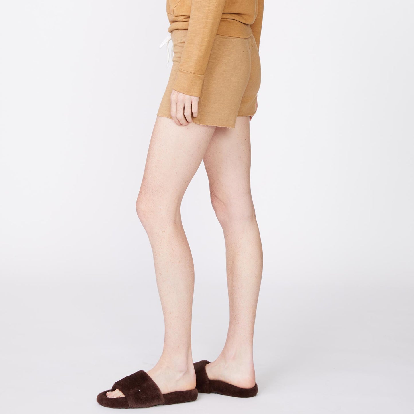 Side view of model wearing the supersoft vintage shorts in latte.