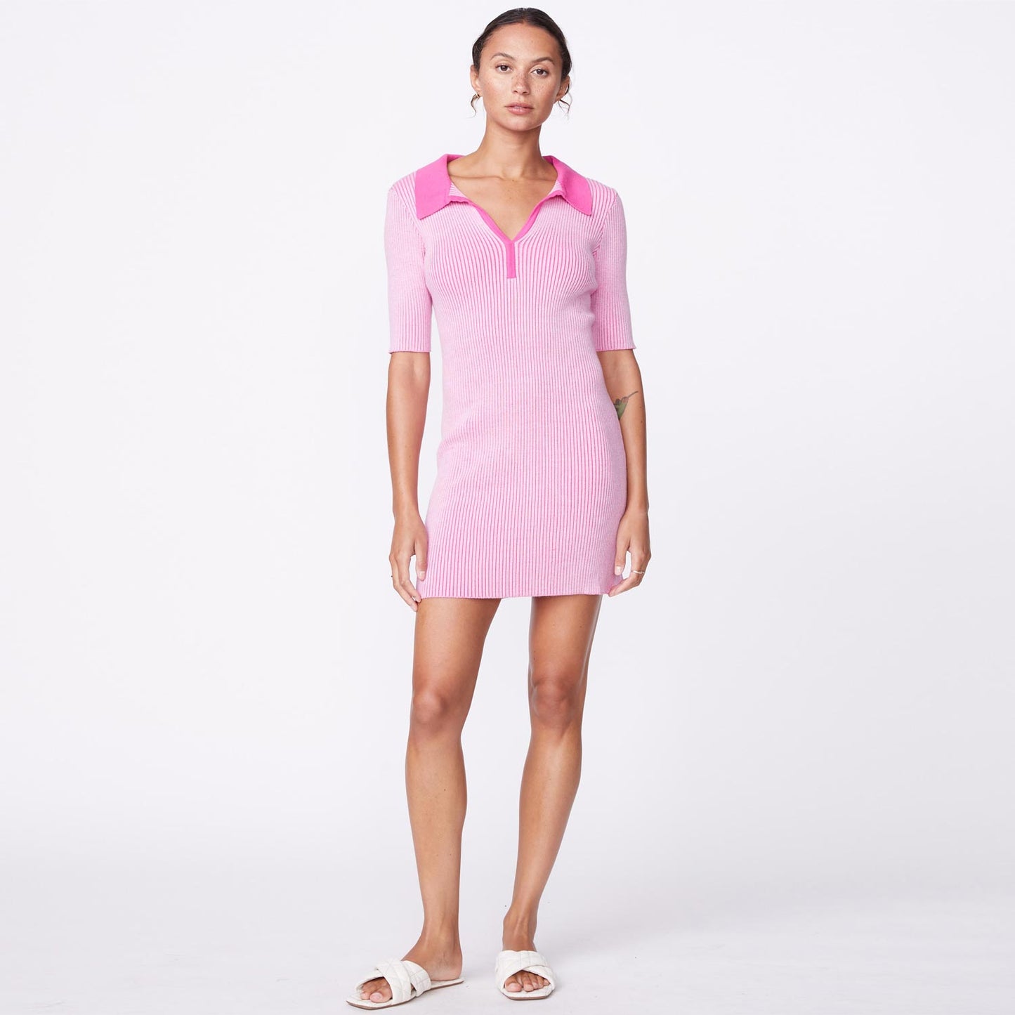 Front view of model wearing the polo sweater dress in bubble gum.