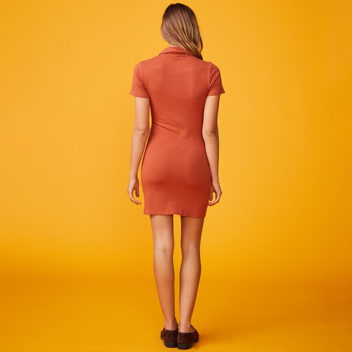 Back view of model wearing the supersoft polo shirred dress in faded rust.