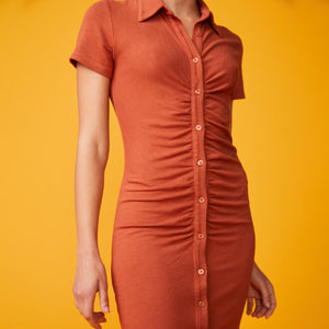 Front view of model wearing the supersoft polo shirred dress in faded rust.