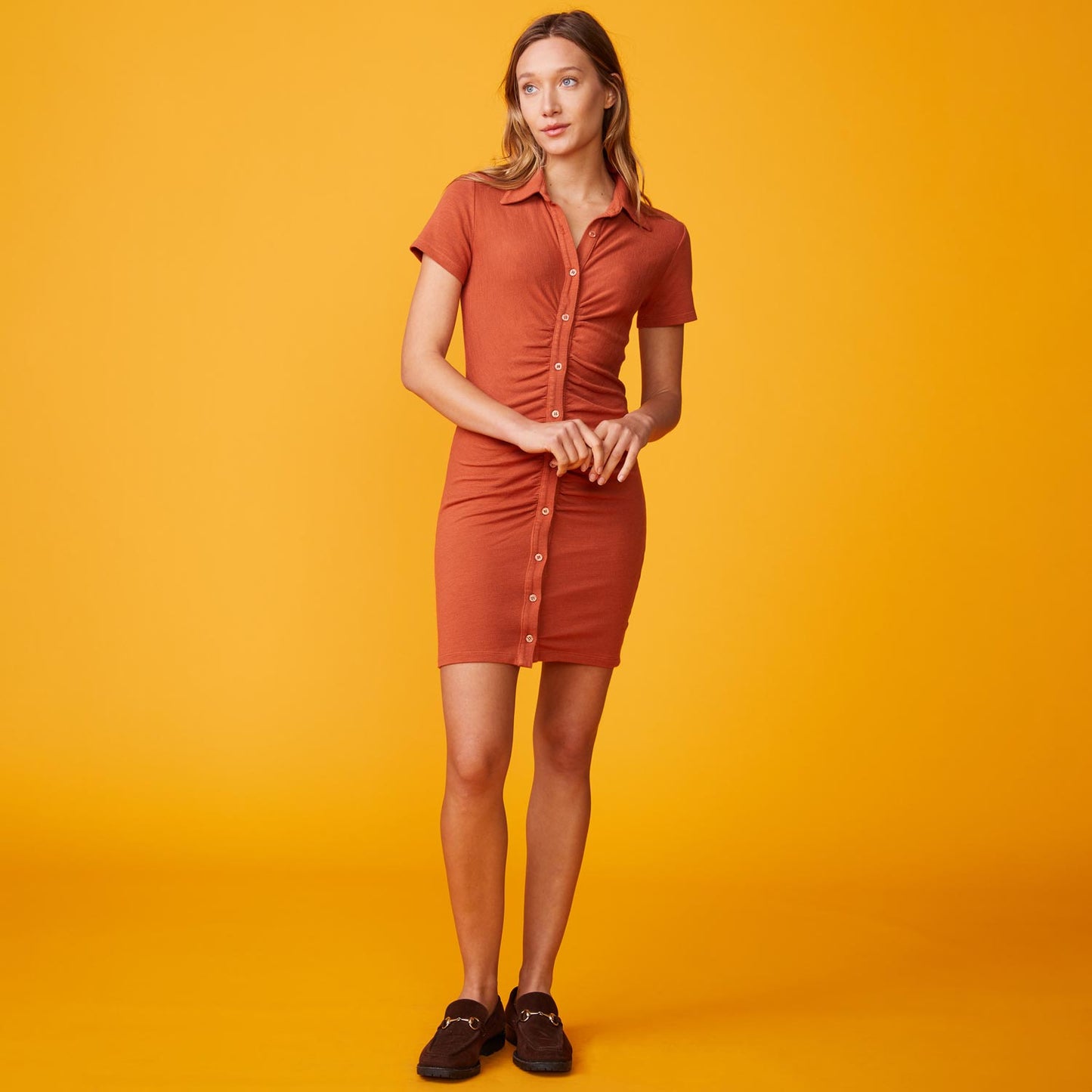 Front view of model wearing the supersoft polo shirred dress in faded rust.