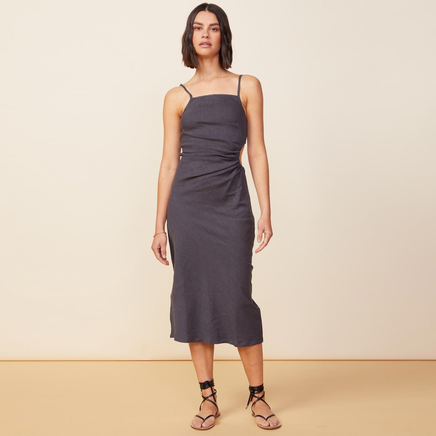 Front view of model wearing the linen slip dress in faded black.
