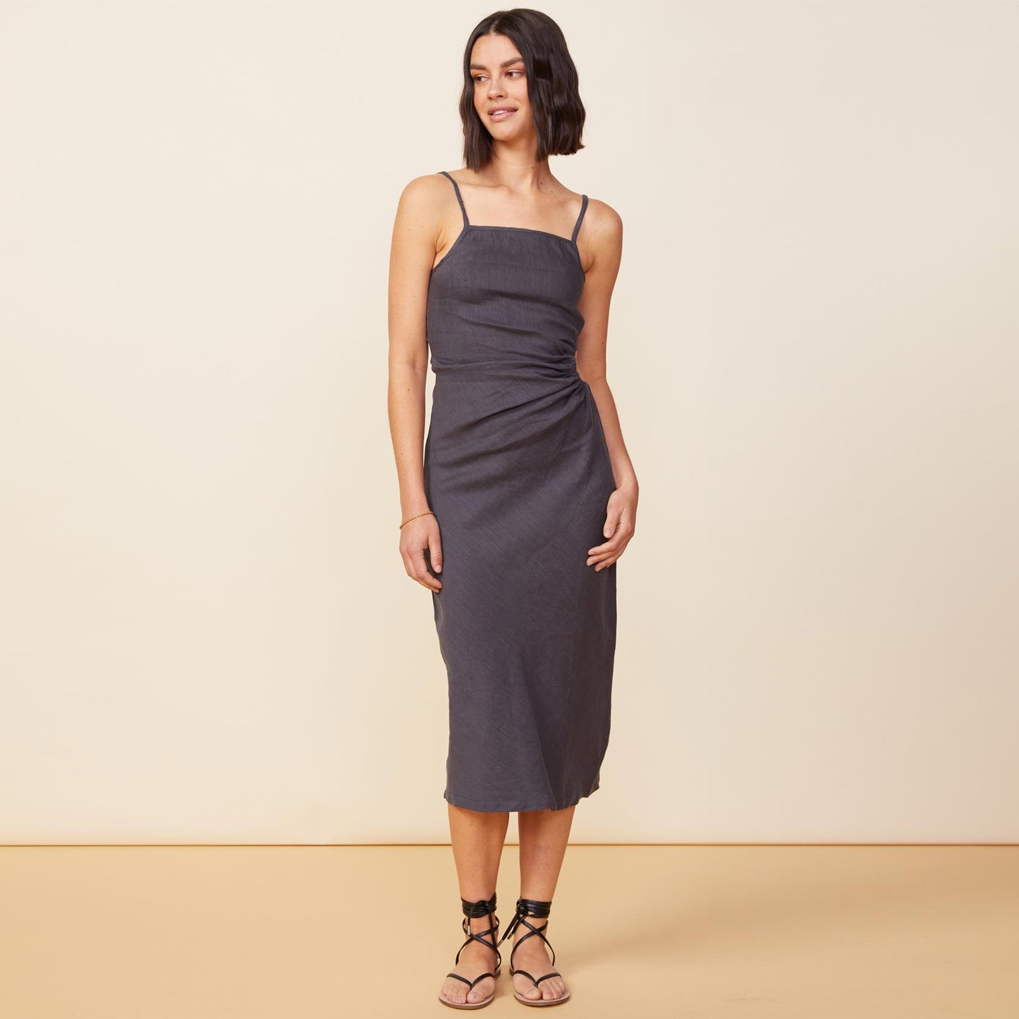 Front view of model wearing the linen slip dress in faded black.
