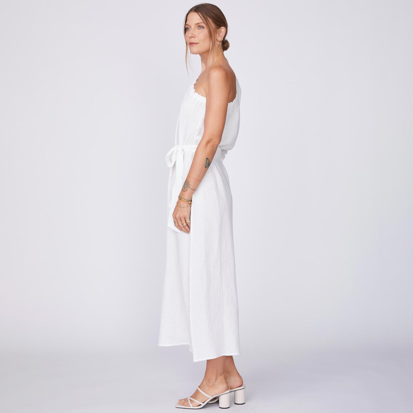 Side View of Model wearing the Gauze One Shoulder Dress in White