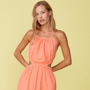 Detail View of model wearing the Cut Out Halter Dress in Georgia Peach.