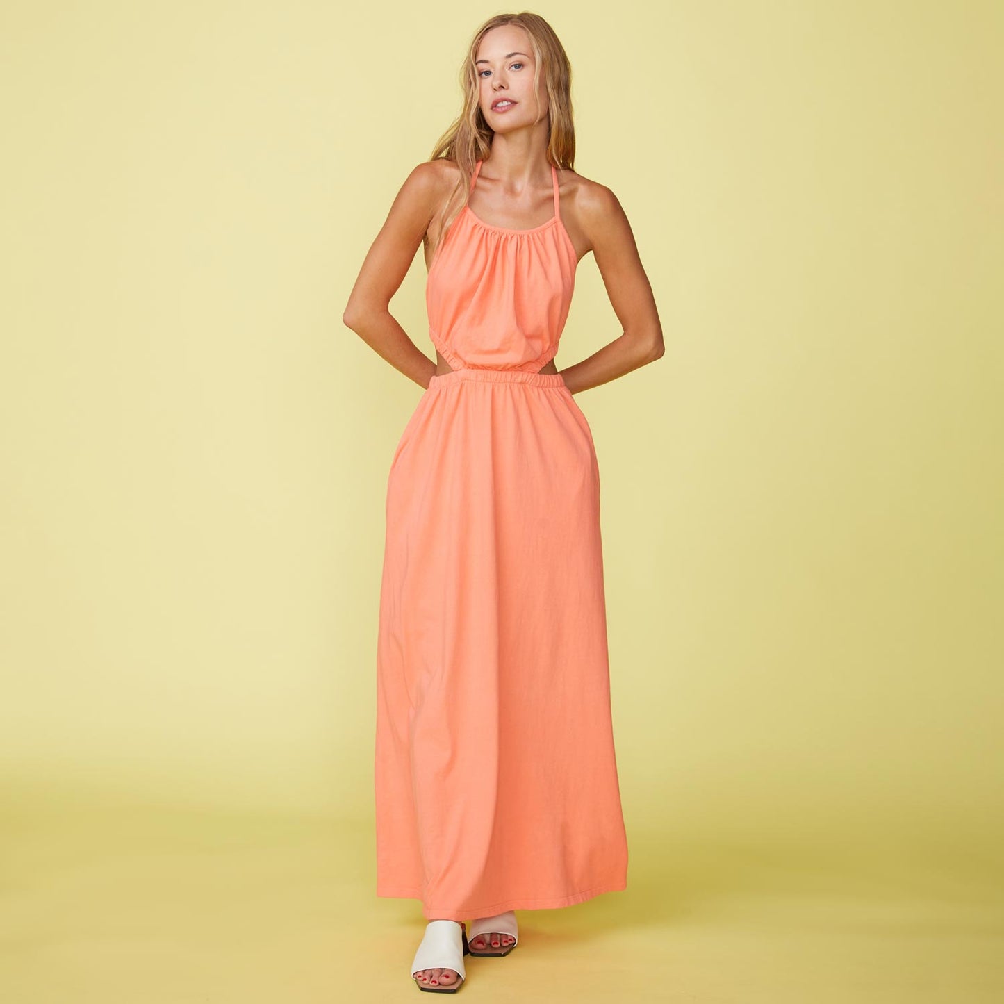 Front View of model wearing the Cut Out Halter Dress in Georgia Peach.