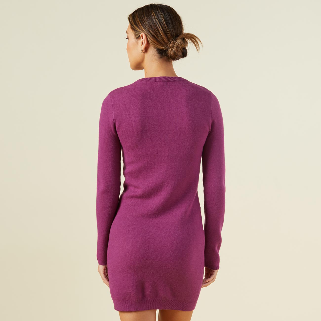 Back view of model wearing the supersoft sweater knit cut out dress in raspberry rose.
