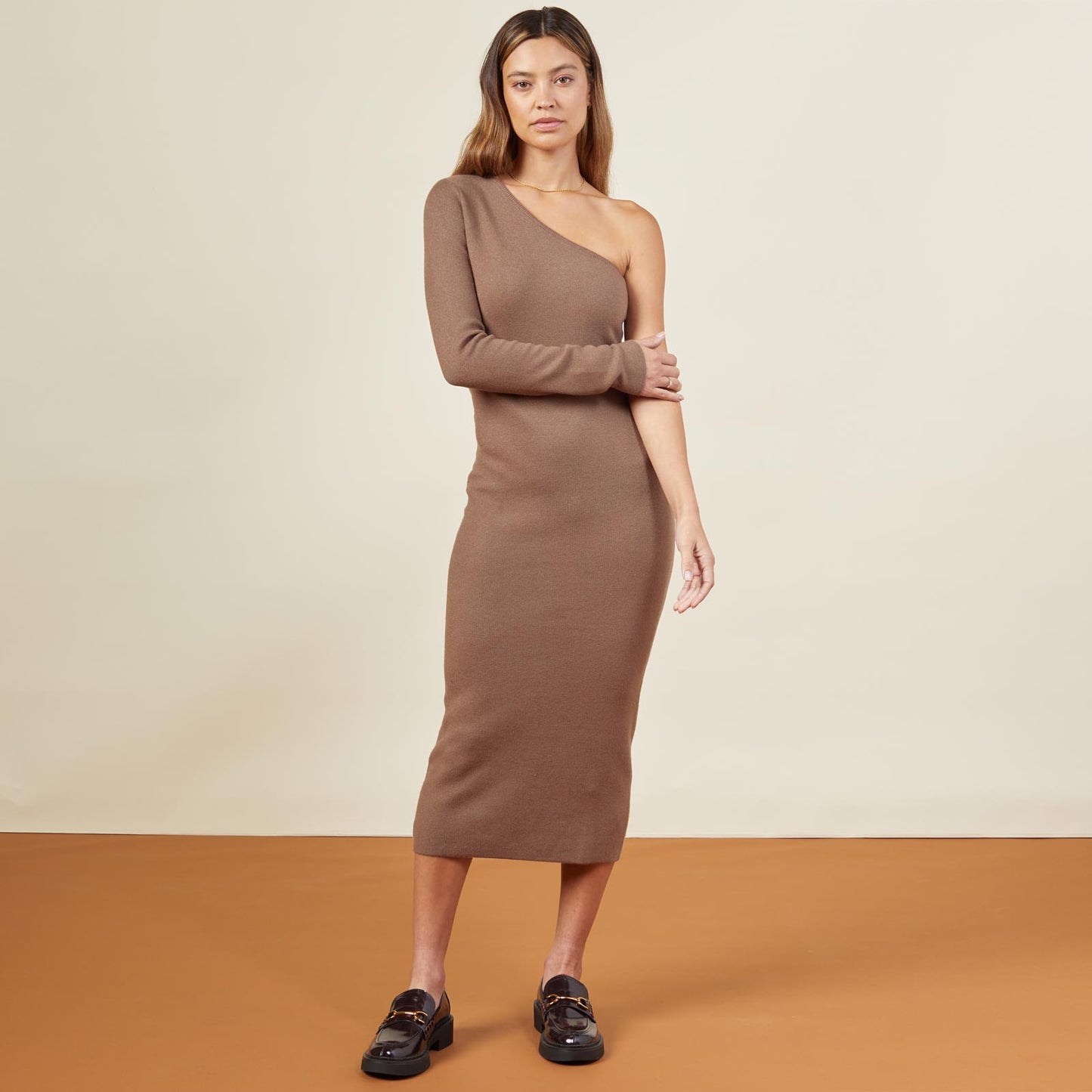 Front view of model wearing the supersoft sweater knit one shoulder dress in dusty cocoa.